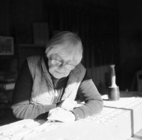 Monica Setziol-Phillips carves at the same bench her father, Leroy Setziol, used. A resident of Sheridan, she is former president of the Yamhill County Cultural Coalition. Photo by: Stuart Eagon